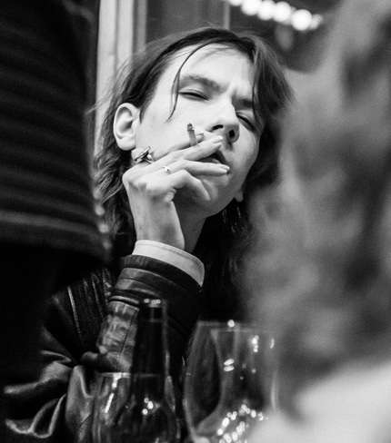 Black-white photo of Valentine Shishka wrapped in cigarette smoke